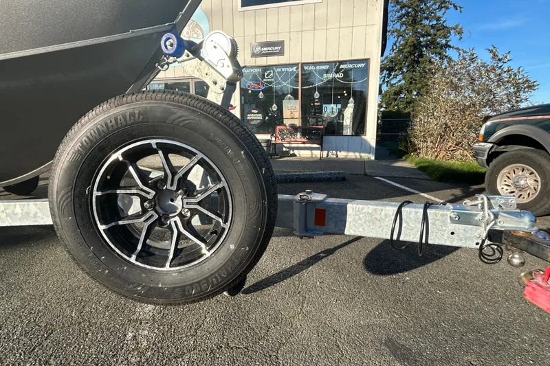 Slide: The Image of 2026 Lowe Fish & Ski 1700 trailer with Townhall tire in a parking lot. - 13