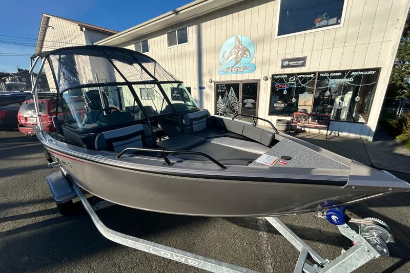 Slide: The Image of 2026 Lowe Fish & Ski 1700 boat on trailer outside dealership. - 17