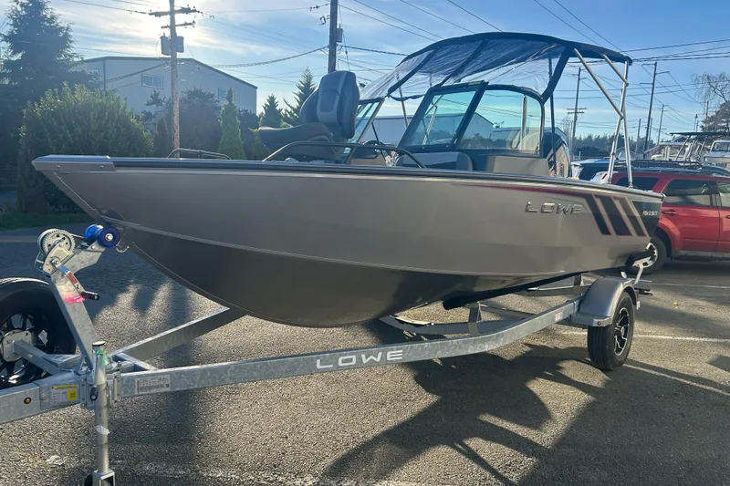 Slide: The Image of 2026 Lowe Fish & Ski 1700 boat on trailer, parked outdoors, sunny day. - 18