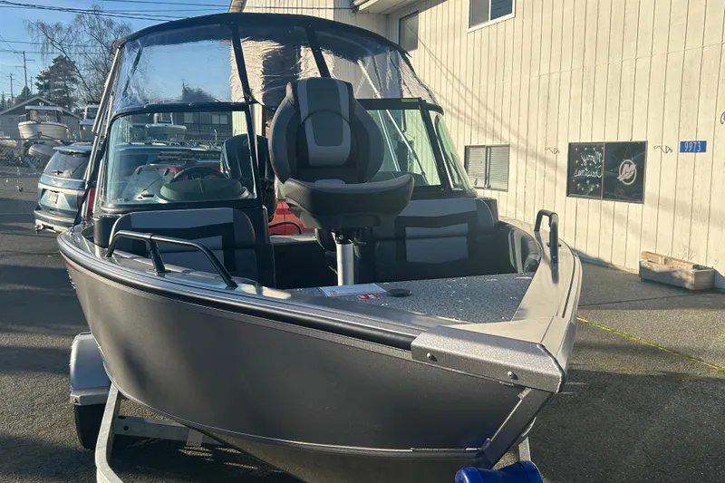 Slide: The Image of 2026 Lowe Fish & Ski 1700 boat on trailer, parked outdoors. - 19