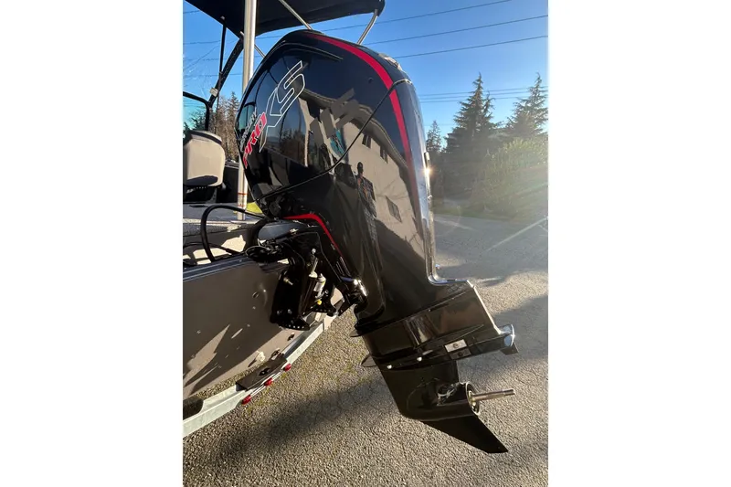 Slide: The Image of 2026 Lowe Fish & Ski 1700 boat with powerful outboard motor in sunlight. - 20