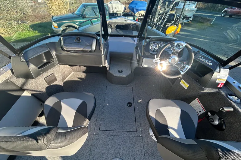 Slide: The Image of 2026 Lowe Fish & Ski 1700 boat interior with steering wheel and seating. - 5
