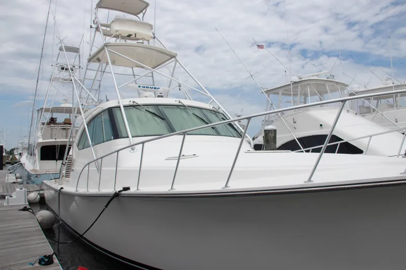 Slide: The Image of 2016 Henriques 42 Express Hardtop yacht docked at marina under cloudy sky. - 10