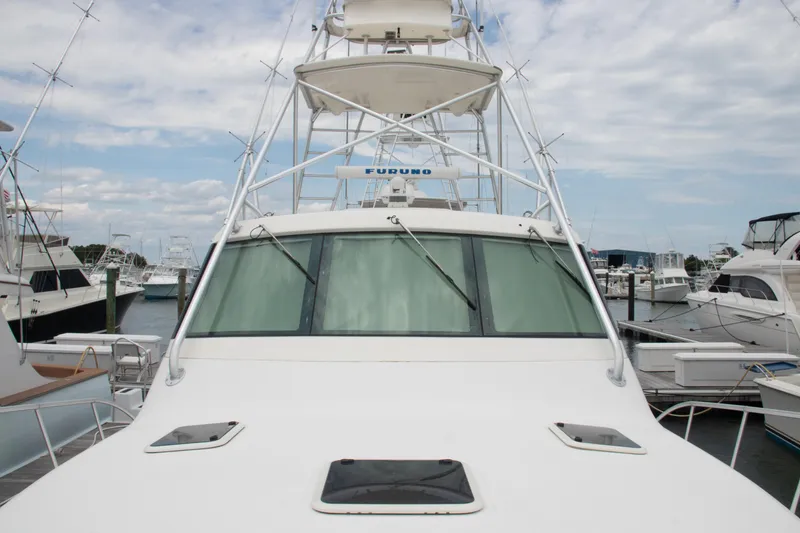 Slide: The Image of 2016 Henriques 42 Express Hardtop boat docked at marina, front view. - 14