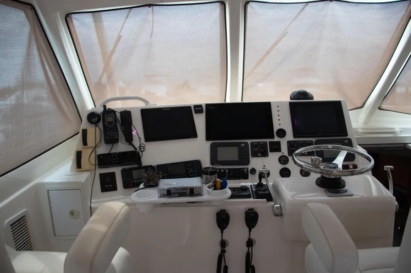 Slide: The Image of Helm of 2016 Henriques 42 Express Hardtop with advanced navigation equipment and steering wheel. - 18