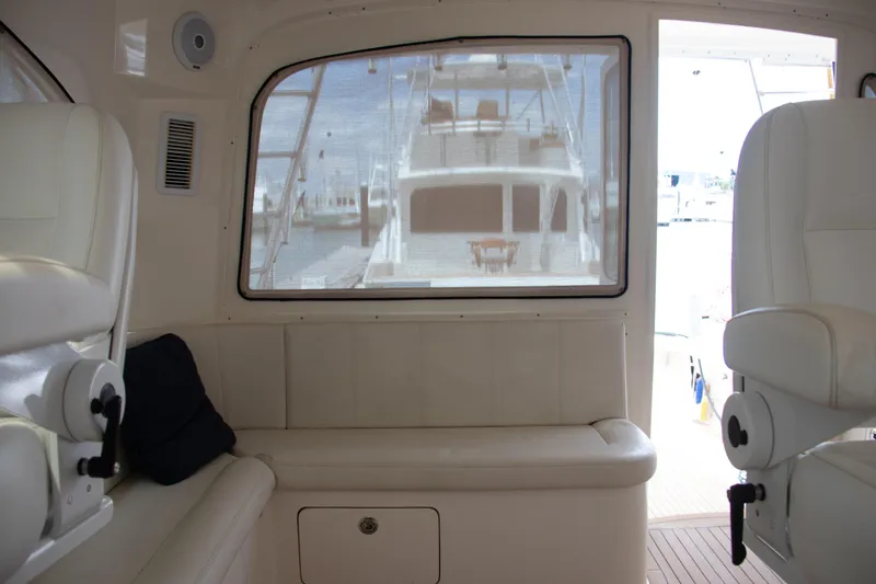 Slide: The Image of Interior view of 2016 Henriques 42 Express Hardtop yacht with white seating and window. - 20