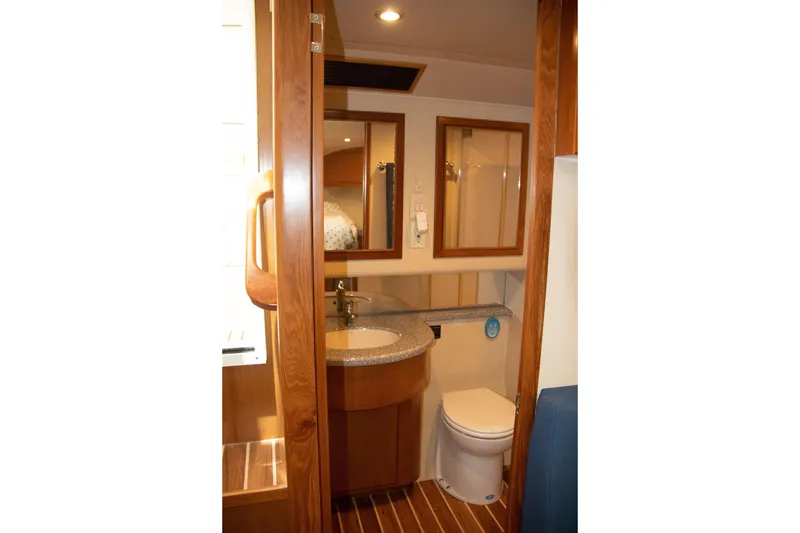 Slide: The Image of 2016 Henriques 42 Express Hardtop yacht bathroom with wooden accents and modern fixtures. - 26