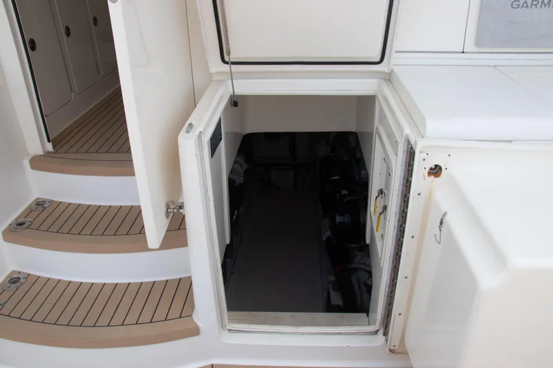 Slide: The Image of 2016 Henriques 42 Express Hardtop engine room access with open hatch and steps. - 28