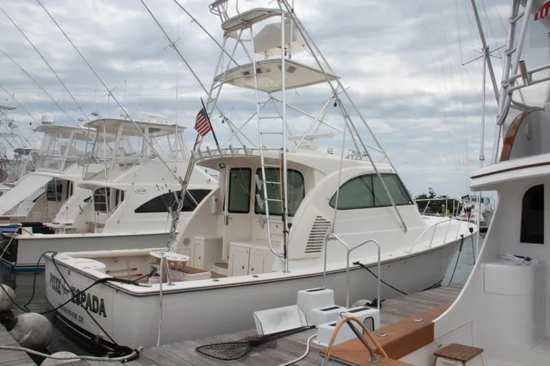 Slide: The Image of 2016 Henriques 42 Express Hardtop docked at marina, surrounded by other boats. - 8