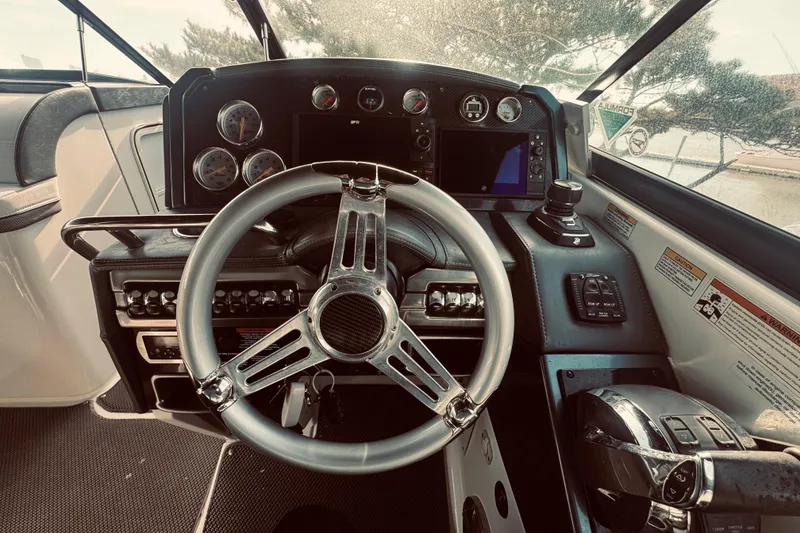 Slide: The Image of 2019 Formula 310 FX Bowrider helm with modern controls and sleek steering wheel. - 15