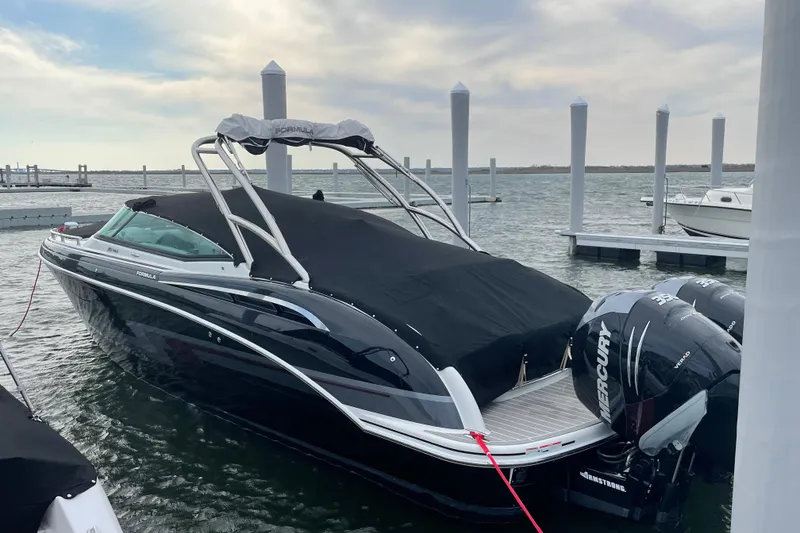 Slide: The Image of 2019 Formula 310 FX Bowrider docked with Mercury outboard engines, covered and ready for adventure. - 3