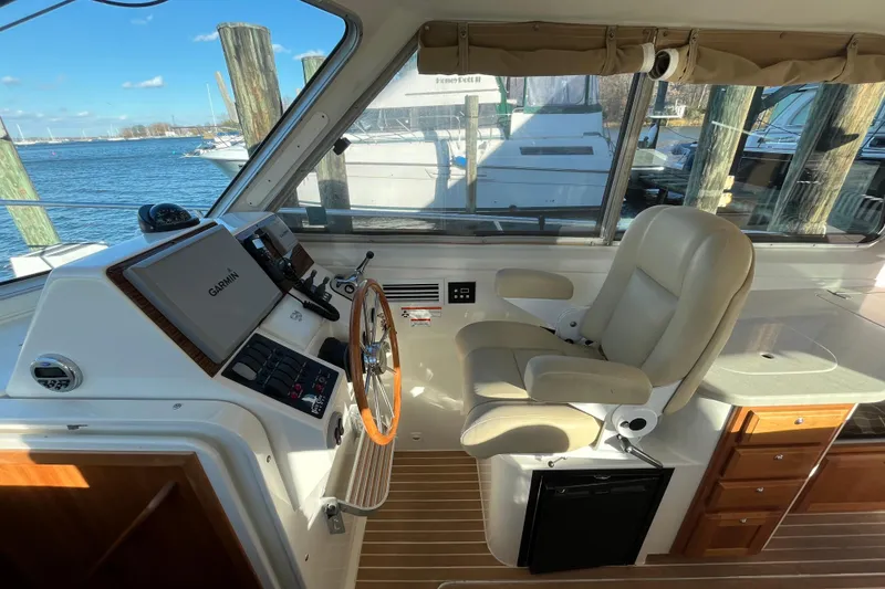 Slide: The Image of 2010 Back Cove 33 Express Hardtop helm with Garmin navigation, leather seat, and wood accents. - 14