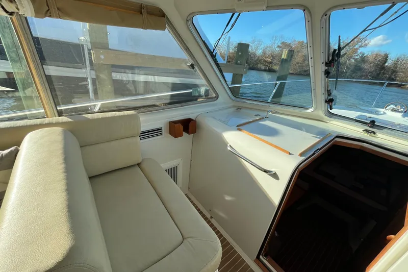 Slide: The Image of Interior of 2010 Back Cove 33 Express Hardtop boat with seating and windows overlooking water. - 17