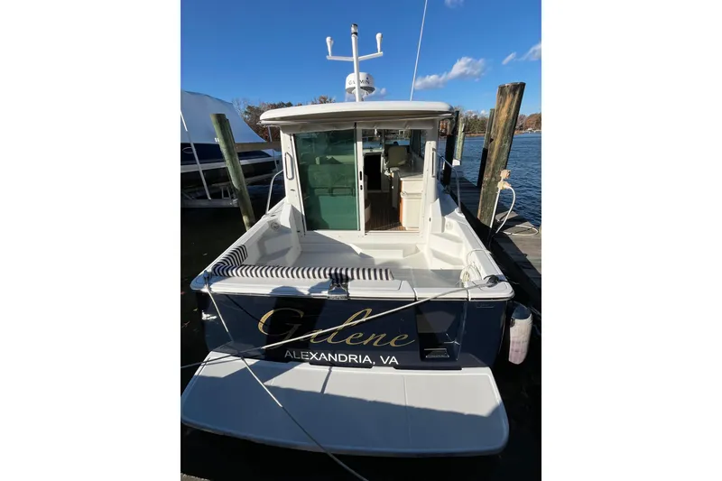 Slide: The Image of 2010 Back Cove 33 Express Hardtop docked, rear view with open cabin door. - 2