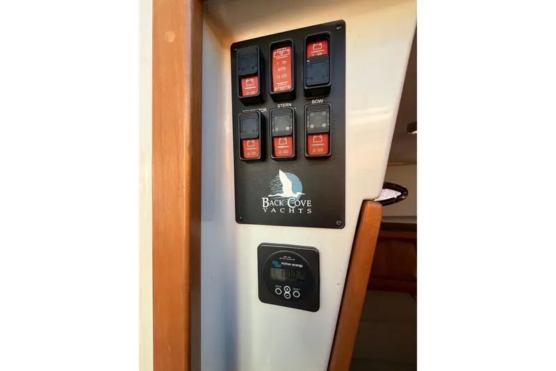 Slide: The Image of Control panel of 2010 Back Cove 33 Express Hardtop yacht with switches and display. - 20