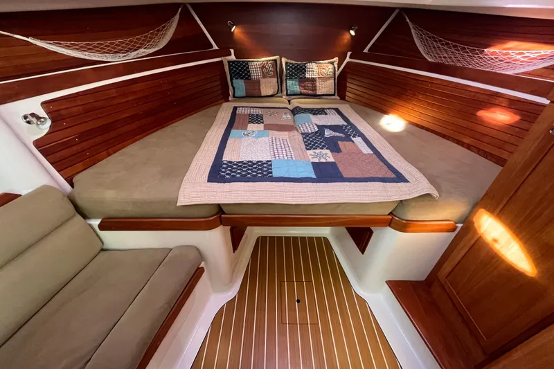 Slide: The Image of 2010 Back Cove 33 Express Hardtop cabin with cozy bed and quilted blanket. - 23