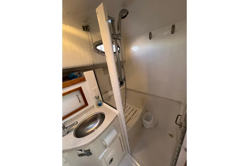 Slide: The Image of 2010 Back Cove 33 Express Hardtop bathroom with sink and shower. - 24