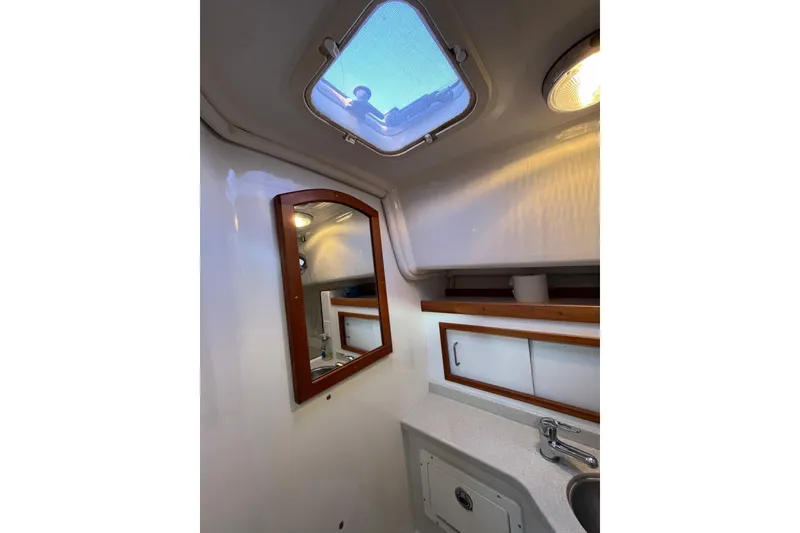 Slide: The Image of 2010 Back Cove 33 Express Hardtop bathroom with skylight, mirror, and sink. - 25