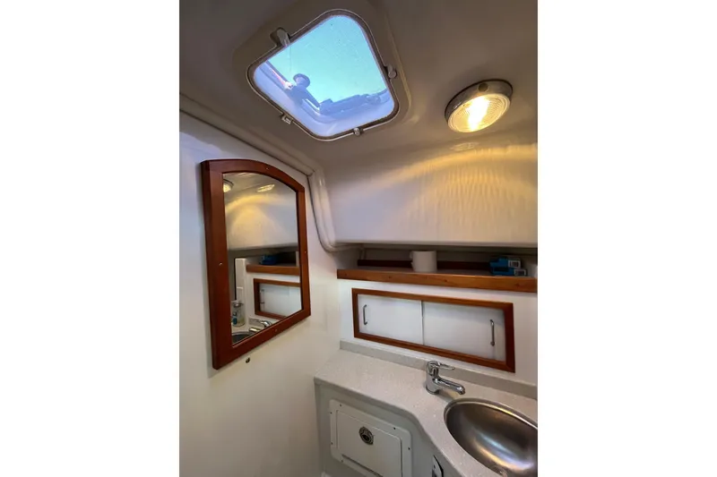 Slide: The Image of 2010 Back Cove 33 Express Hardtop bathroom with skylight, mirror, and sink. - 26