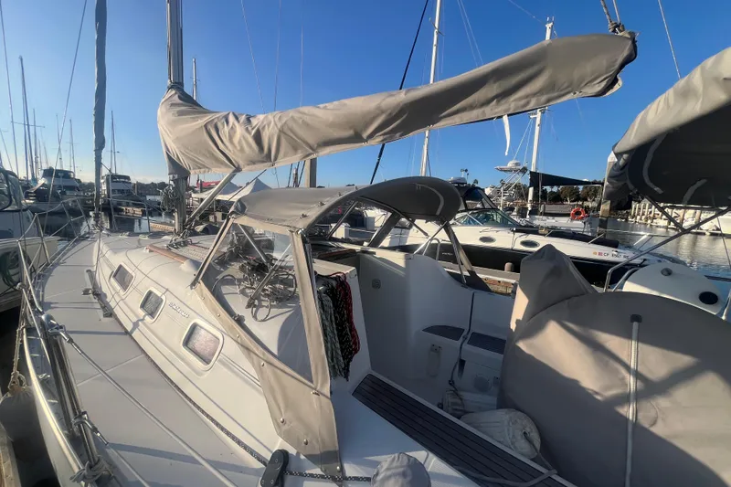 Slide: The Image of 2005 Beneteau 323 sailboat docked at marina under clear blue sky. - 2