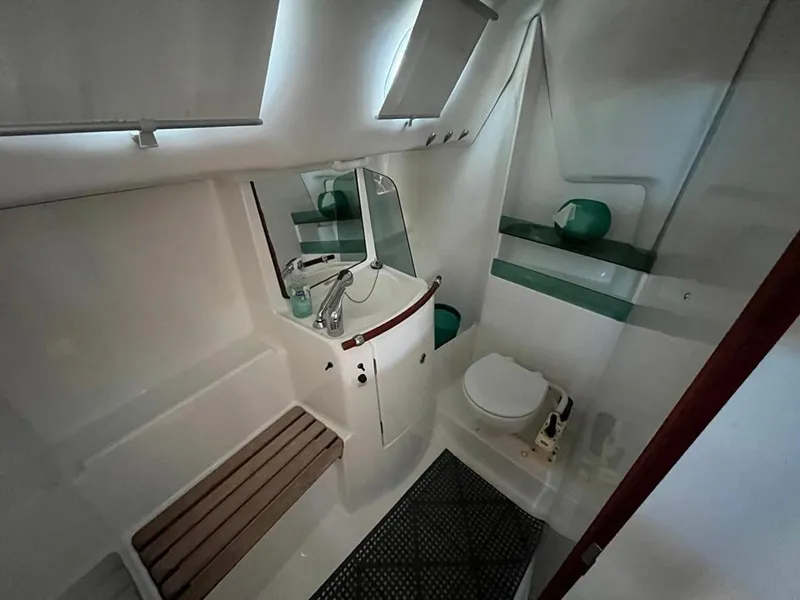 Slide: The Image of Bathroom interior of 2005 Beneteau 323 yacht, featuring sink, toilet, and shower area. - 35