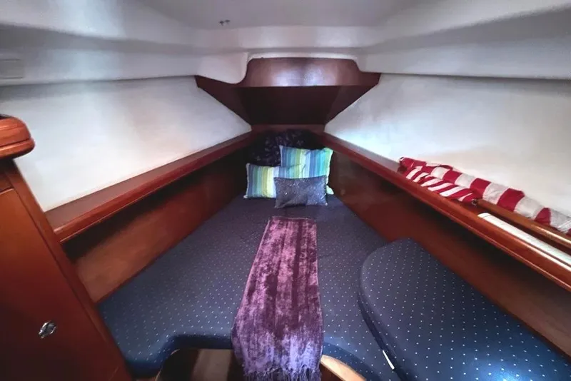 Slide: The Image of Cozy cabin interior of a 2005 Beneteau 323 sailboat with cushions and wooden accents. - 39