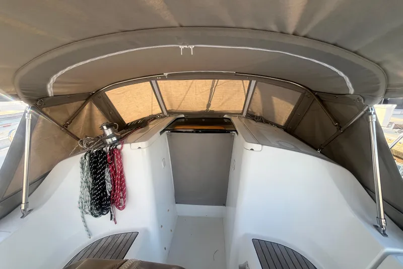 Slide: The Image of 2005 Beneteau 323 sailboat cockpit with canopy and ropes, showcasing interior details. - 40