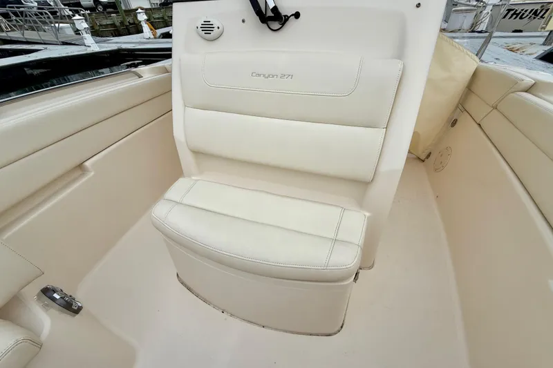 Slide: The Image of 2022 Grady-White Canyon 271 boat interior with cushioned seating. - 13