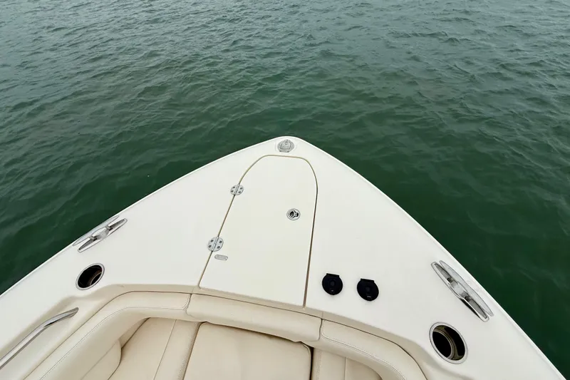 Slide: The Image of Bow of 2022 Grady-White Canyon 271 boat on calm water. - 16