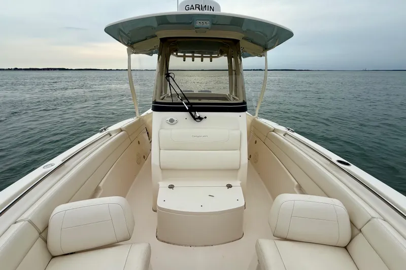 Slide: The Image of 2022 Grady-White Canyon 271 boat interior on calm water, featuring spacious seating. - 19