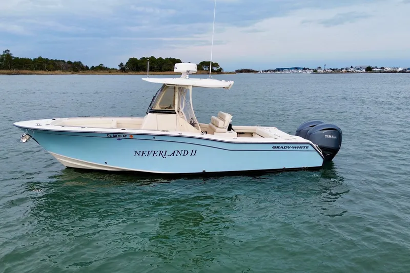 Slide: The Image of 2022 Grady-White Canyon 271 boat named "Neverland II" on calm water. - 2