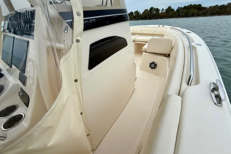 Slide: The Image of 2022 Grady-White Canyon 271 boat interior with seating and control panel on water. - 21