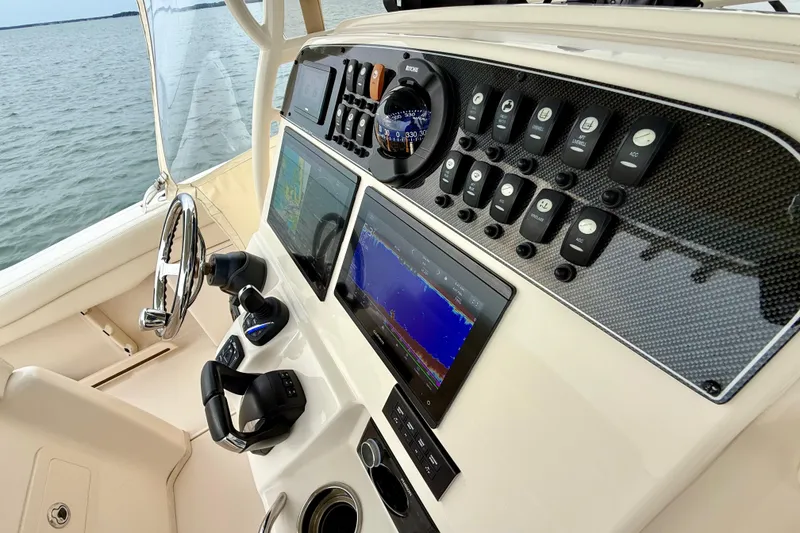Slide: The Image of 2022 Grady-White Canyon 271 boat dashboard with advanced navigation controls and displays. - 24