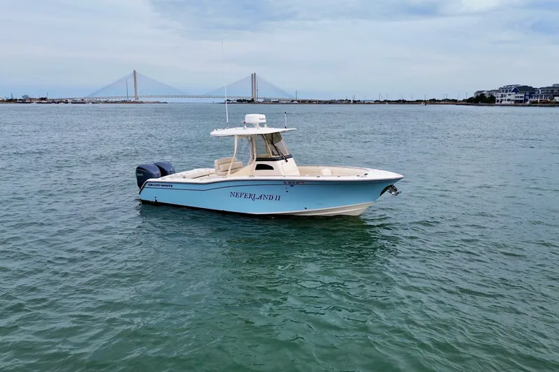 Slide: The Image of 2022 Grady-White Canyon 271 boat on water with bridge in background. - 3