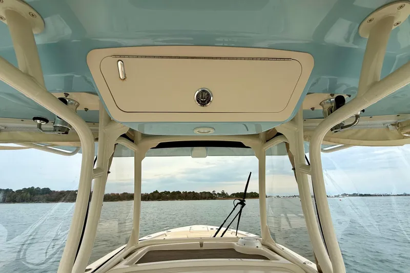 Slide: The Image of 2022 Grady-White Canyon 271 boat interior with ocean view and overhead storage. - 30