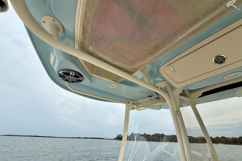 Slide: The Image of 2022 Grady-White Canyon 271 boat interior, featuring overhead storage and speaker system. - 32