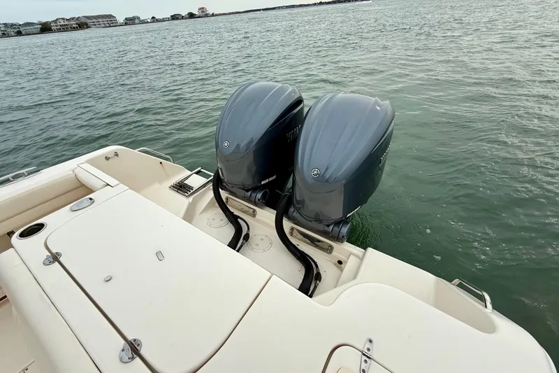 Slide: The Image of 2022 Grady-White Canyon 271 boat with twin outboard motors on calm water. - 34