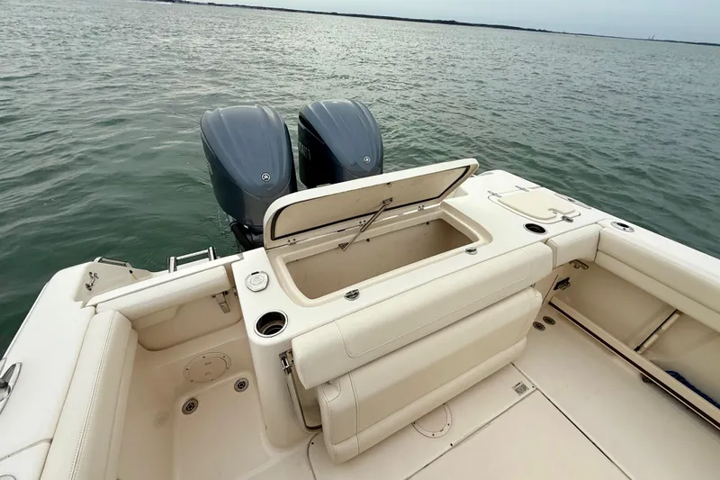 Slide: The Image of 2022 Grady-White Canyon 271 boat with dual engines on calm water. - 35