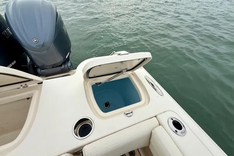 Slide: The Image of 2022 Grady-White Canyon 271 boat with open storage compartment and Yamaha outboard motor. - 36