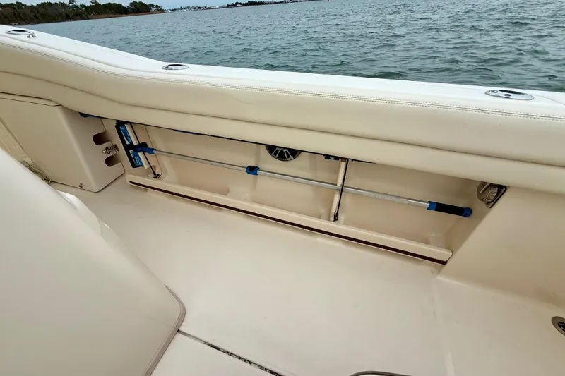 Slide: The Image of 2022 Grady-White Canyon 271 boat interior with rod storage by the water. - 38