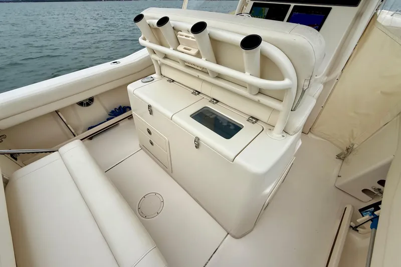 Slide: The Image of 2022 Grady-White Canyon 271 boat interior with rod holders and seating. - 39