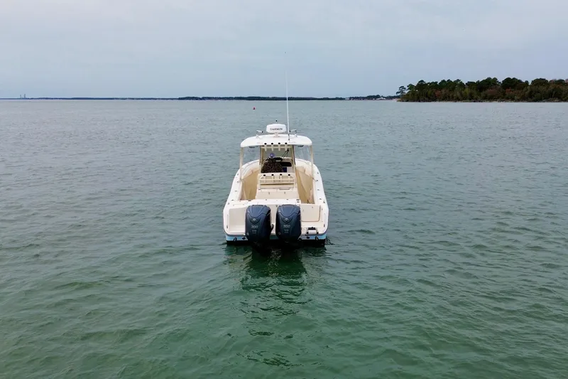 Slide: The Image of 2022 Grady-White Canyon 271 boat on calm water, rear view. - 4