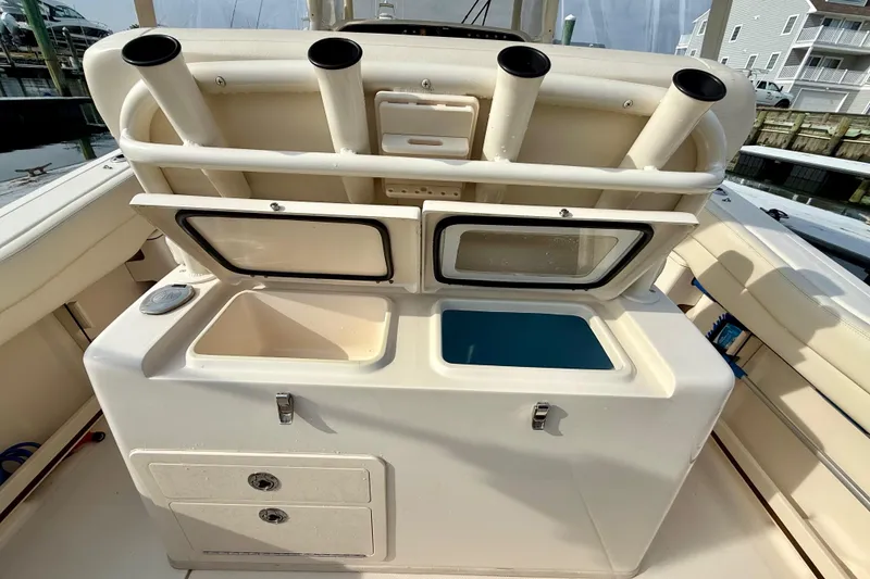 Slide: The Image of 2022 Grady-White Canyon 271 boat with rod holders and storage compartments. - 40