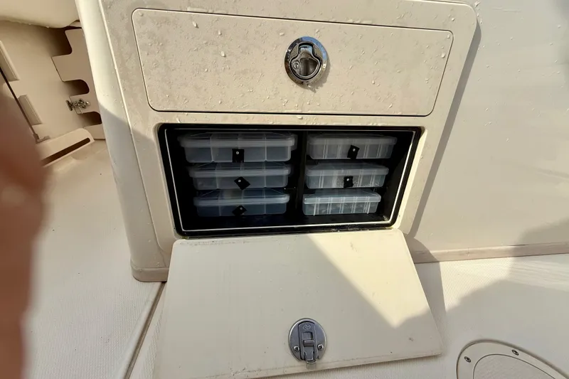 Slide: The Image of Storage compartment with tackle boxes on a 2022 Grady-White Canyon 271 boat. - 42