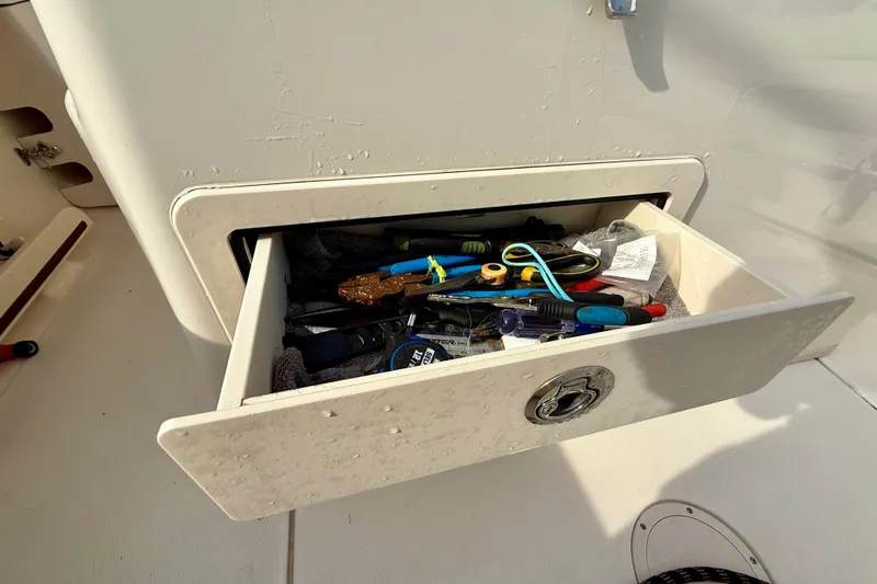 Slide: The Image of Open drawer with tools on a 2022 Grady-White Canyon 271 boat. - 43