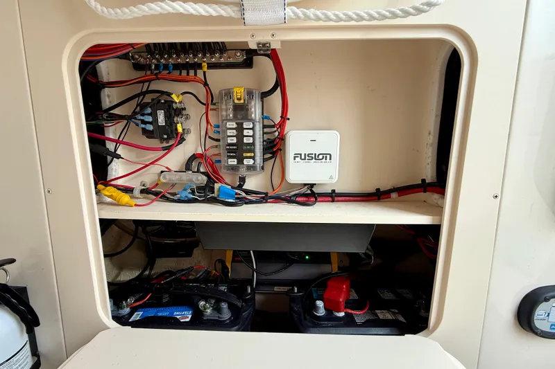Slide: The Image of Electrical panel and battery compartment of 2022 Grady-White Canyon 271 boat. - 48