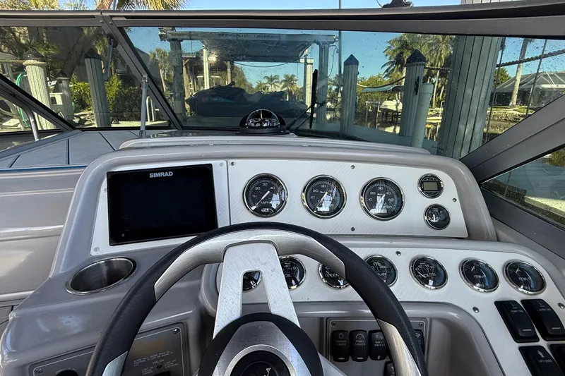 Slide: The Image of 1999 Formula 280 Sun Sport boat interior with steering wheel and seating. - 10