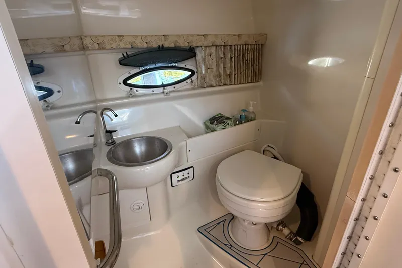 Slide: The Image of 1999 Formula 280 Sun Sport cabin with beige seating and mirrored door. - 17