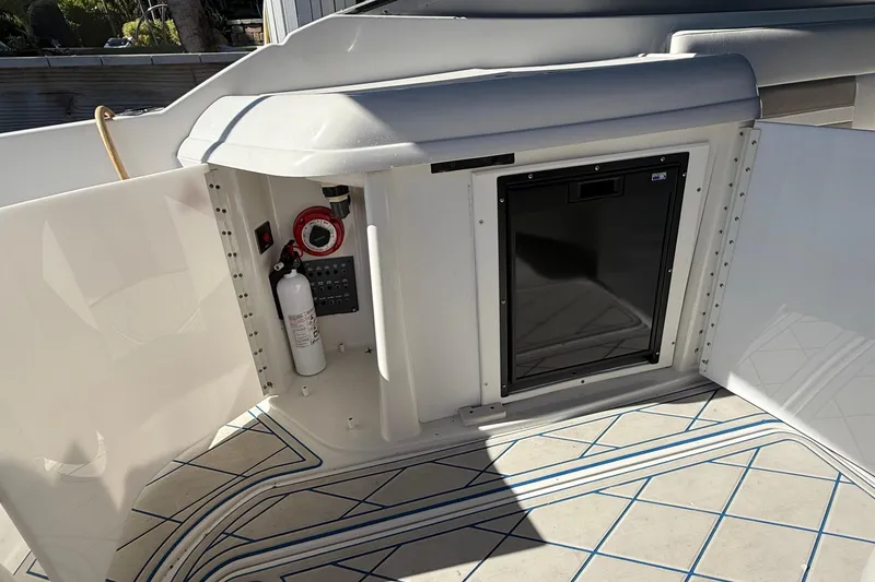 Slide: The Image of Interior of a 1999 Formula 280 Sun Sport boat with beige seating and modern amenities. - 18