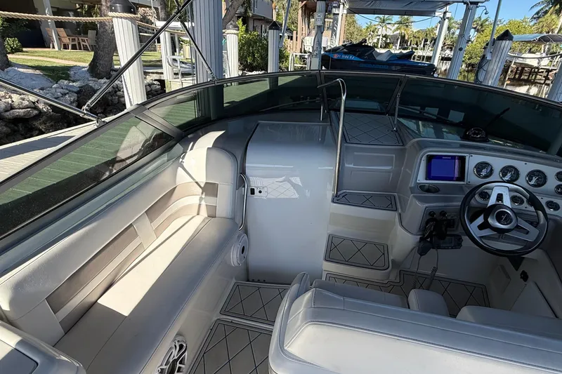 Slide: The Image of 1999 Formula 280 Sun Sport boat interior with white seating and water view. - 7
